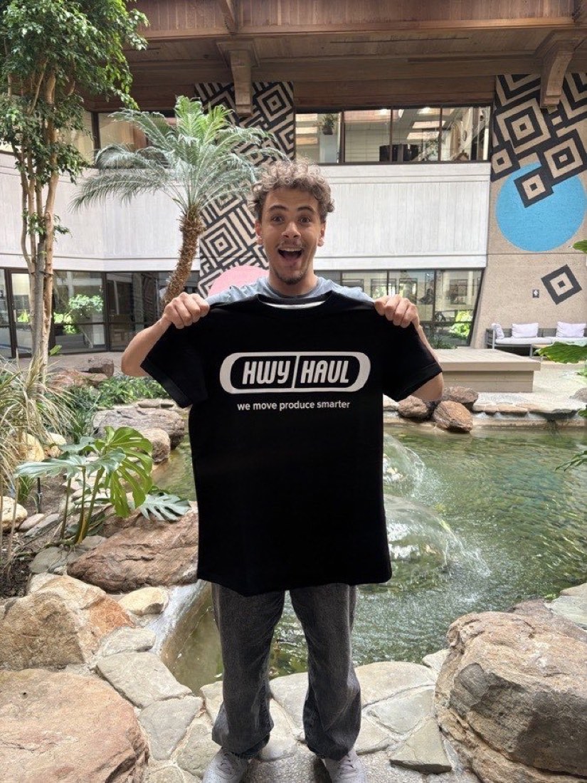 Yusuf Gadelrab, founder of FreightDesk AI, holding a HwyHaul freight-tech shirt